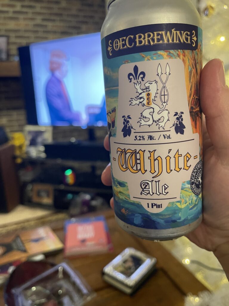 In the foreground, a can of OEC Brewing White Ale. In the background, the Rifftrax team roasts the short Get That Job. 