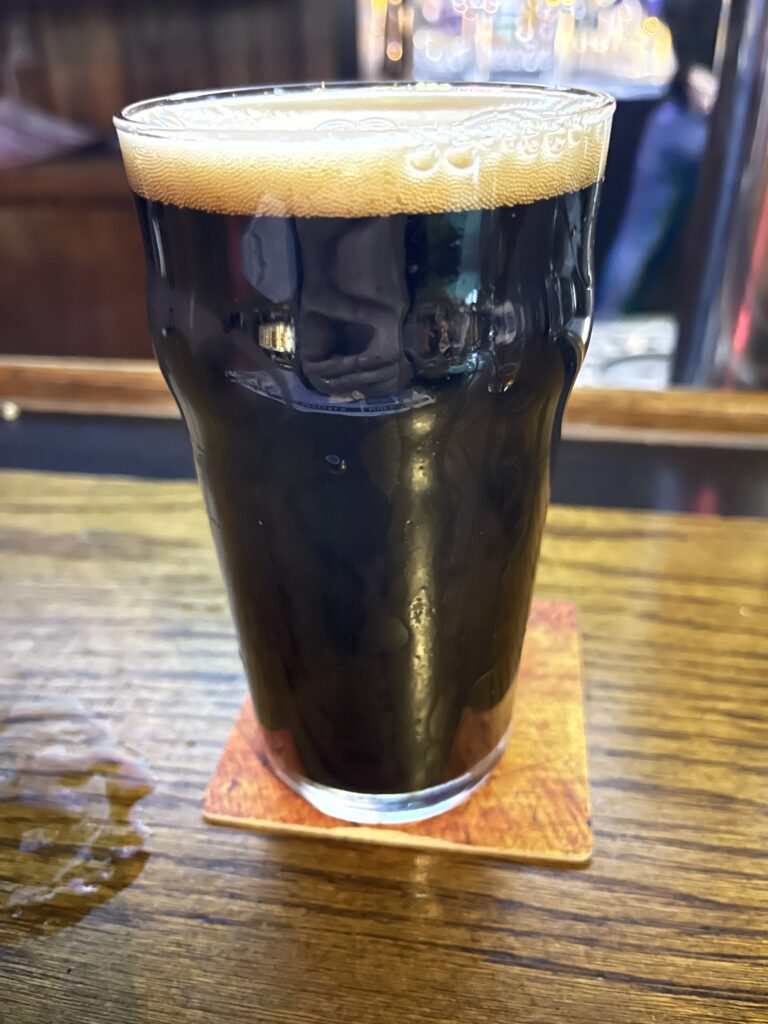 A glass of Founders Porter on the bar at the Winking Lizard
