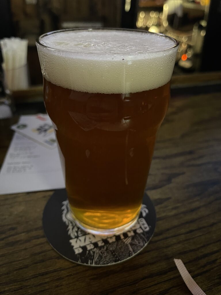 A glass of Bell’s Two Hearted IPA on the bar at the Winking Lizard