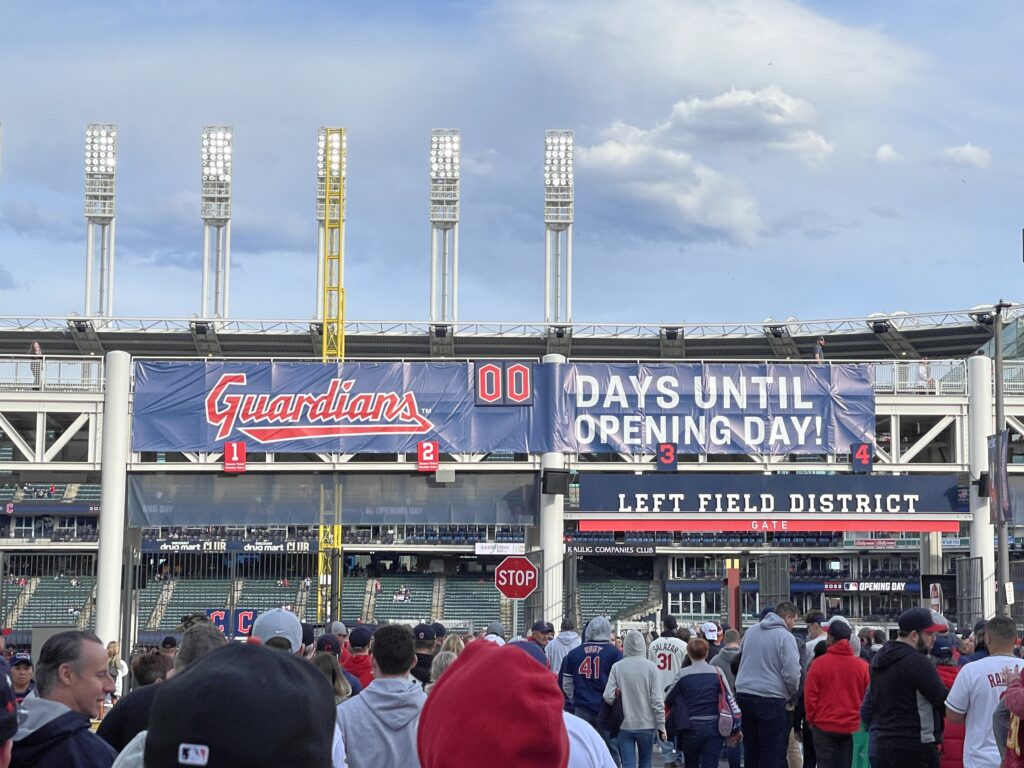The right field gate at Progressive Field at the 2022 Cleveland Guardians home opener.  Fans are lined up waiting to enter. There is a sign stating "00 DAYS UNTIL OPENING DAY"