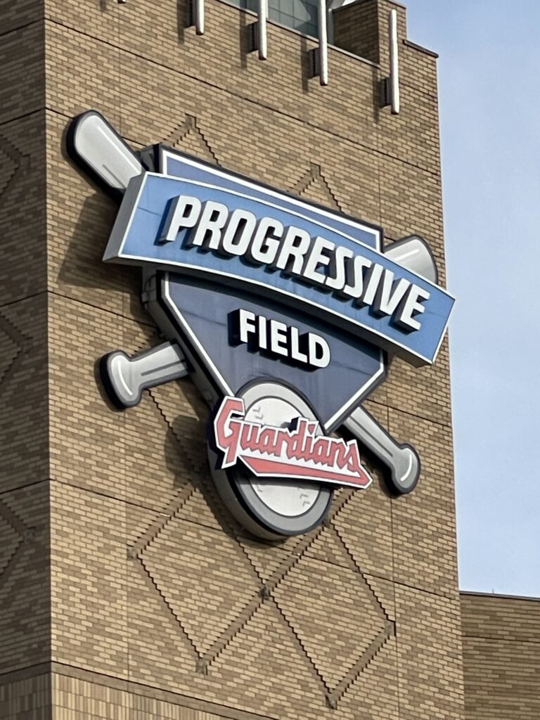The Progressive Field sign on the wall of the stadium, featuring the Cleveland Guardians logo