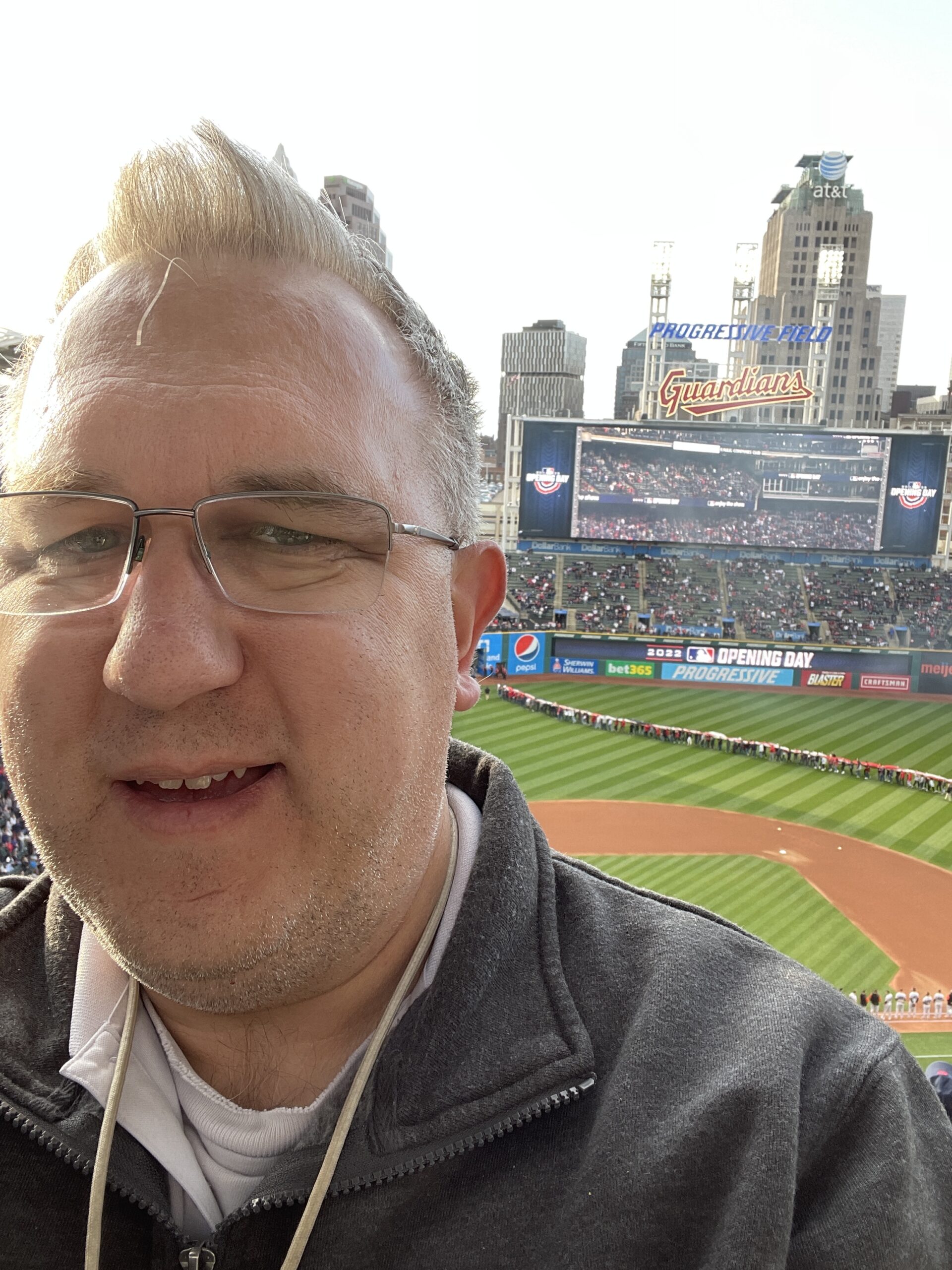 A selfie of me with the Progressive field scoreboard and field in the background