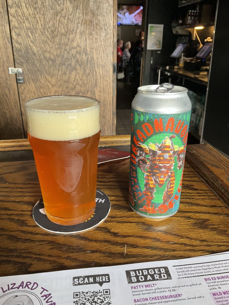 A glass of 3 Floyds Dreadnought Imperial IPA on the bar at the Winking Lizard. The beer’s can odd to the right of the glass. 