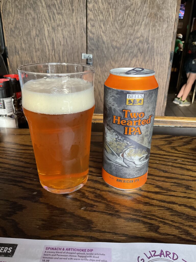 A glass of Bell’s Two Hearted Ale IPA on the bar at the Winking Lizard. The beer’s can is to the right of the glass. 