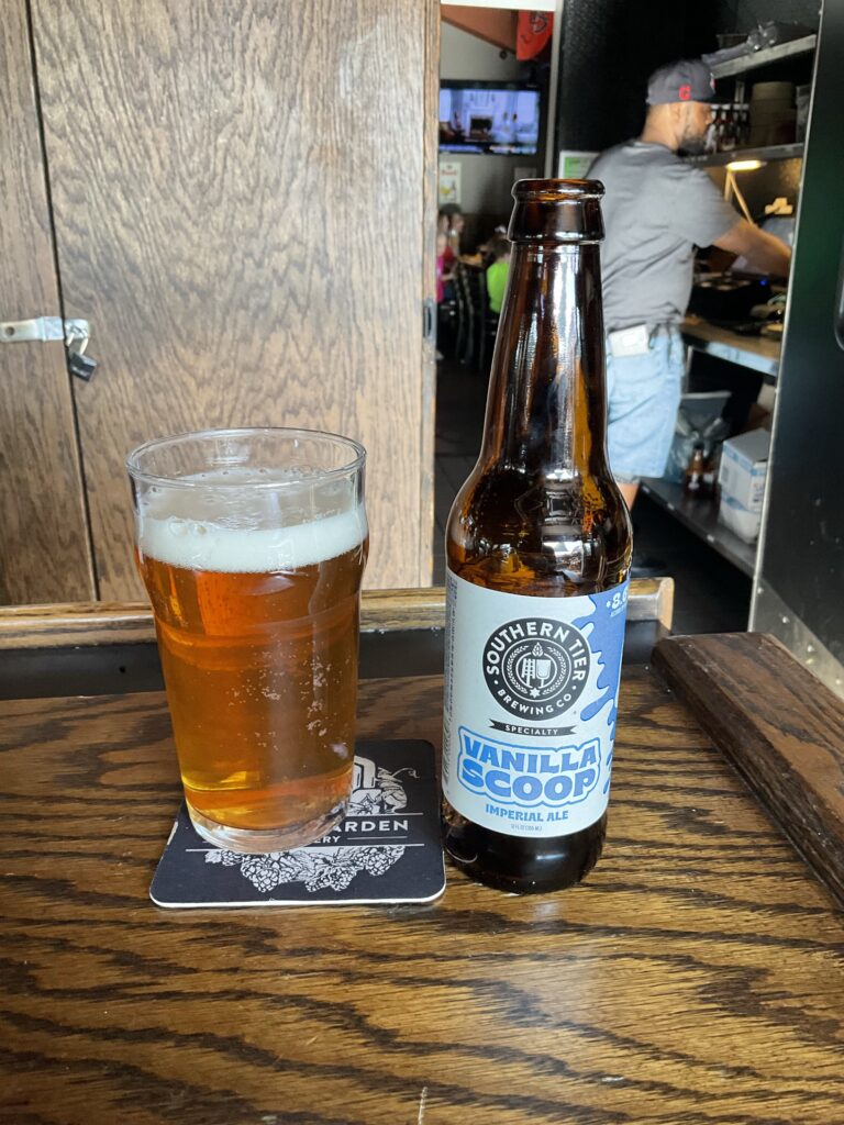 A glass of Southern Tier Vanilla Scoop strong ale on the bar at the Winking Lizard. The beer’s bottle is to the right of the glass. 
